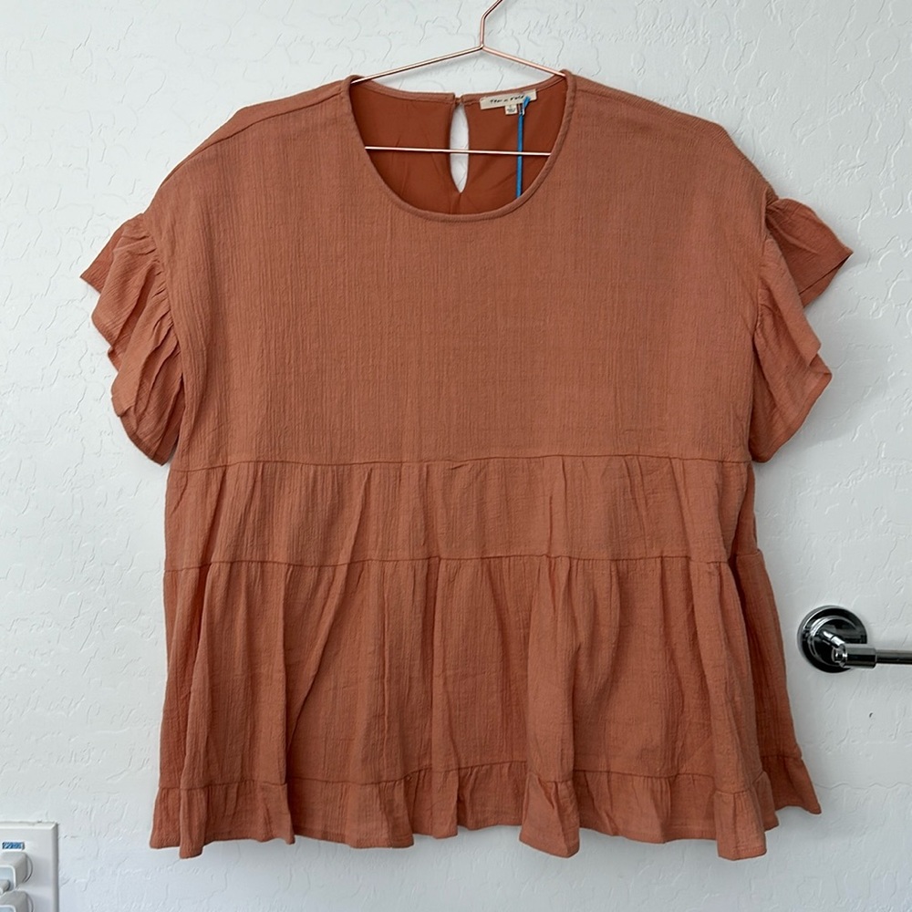 Peach peplum blouse. New with tags.